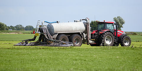 Tractor distributes organic fertilizer on a field